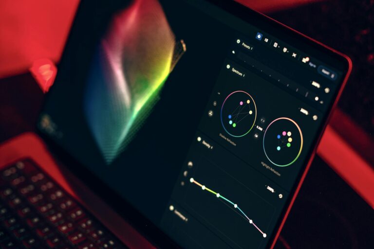 A close-up shot of a laptop displaying a color grading dashboard with vibrant colors.